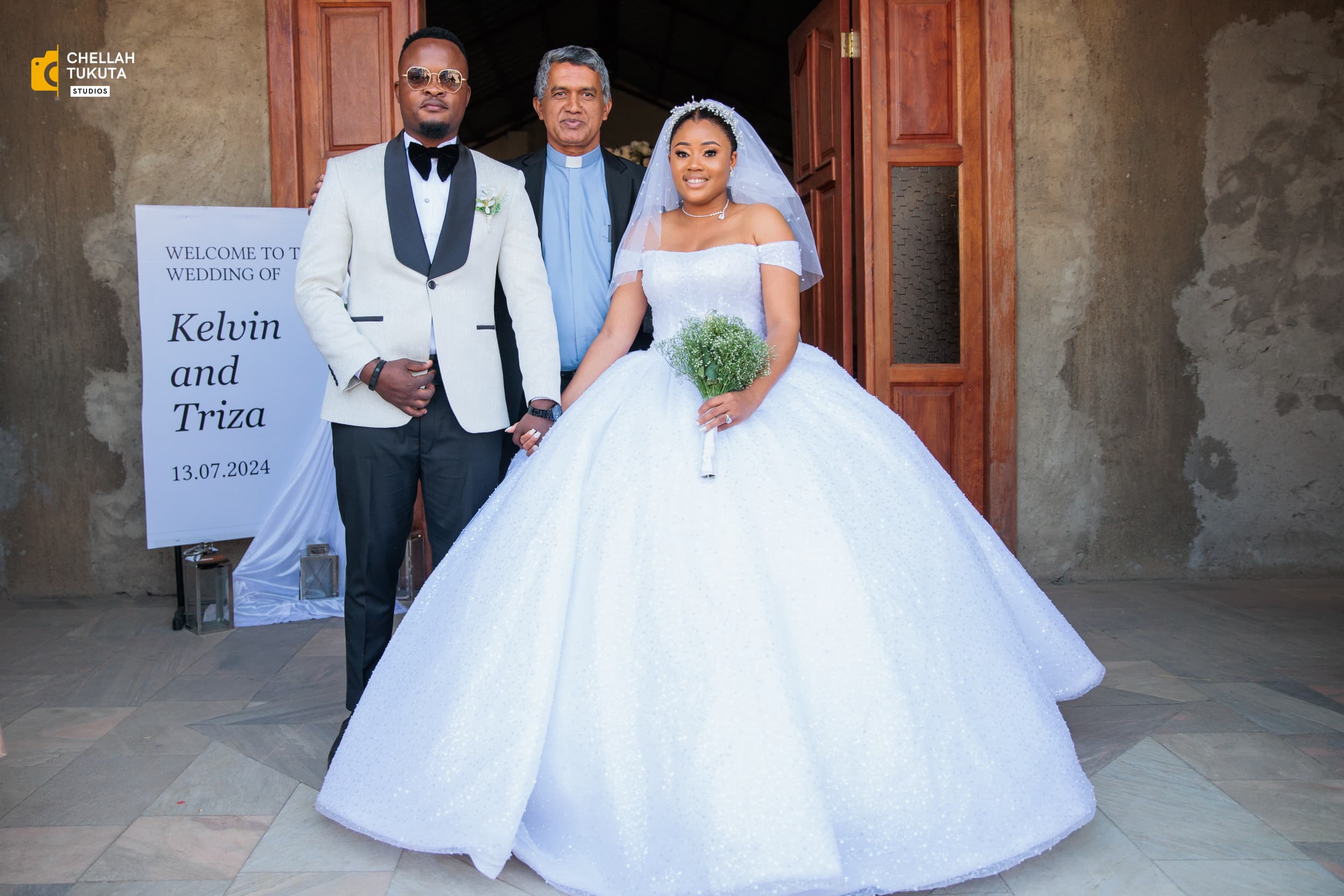 Sacred ceremony moment - couple with officiant at church entrance
