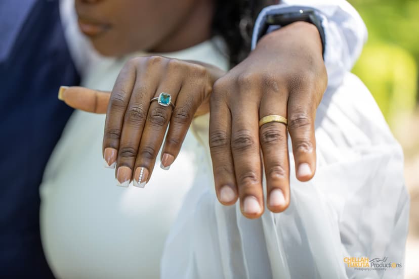 Wedding rings close-up showing emerald engagement ring and gold wedding bands